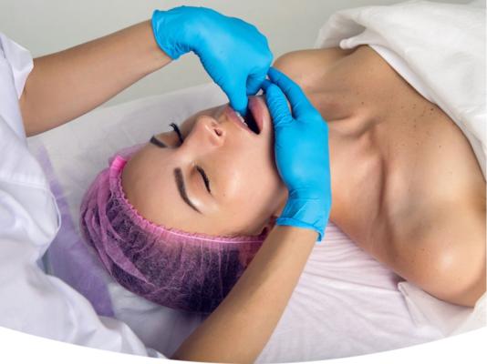 Therapist performing a buccal massage for jaw tension relief