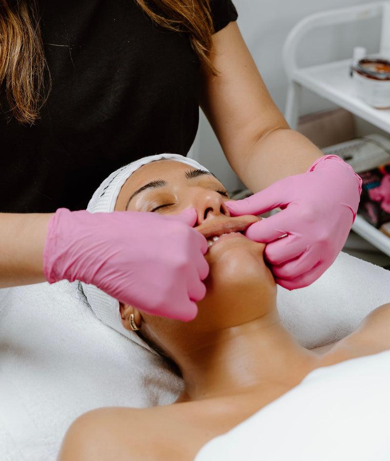 Wellness therapist providing facial massage